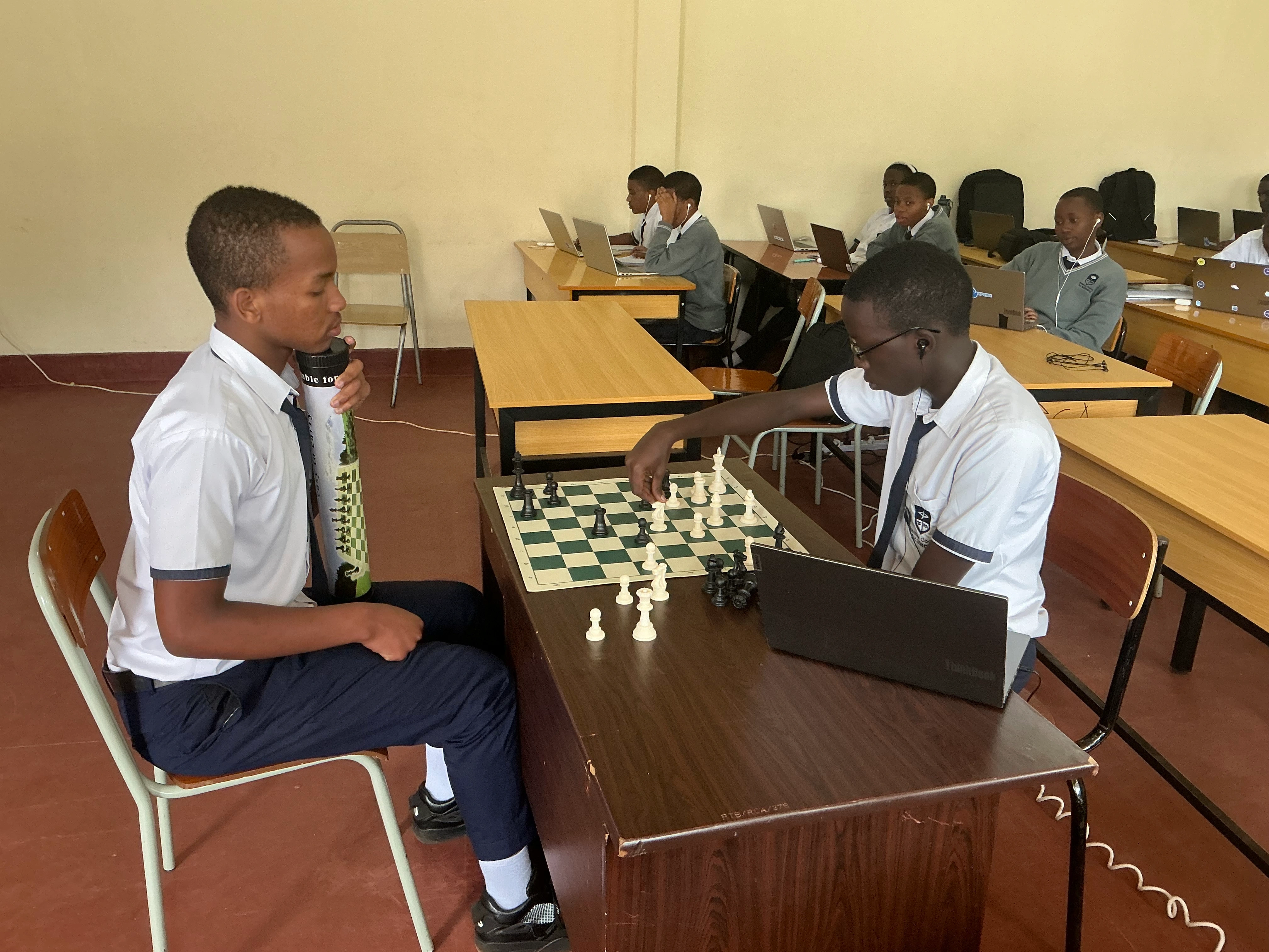 Students playing chess game